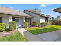 Charming single-story home featuring a well-maintained lawn and sidewalk leading to the front door at 2576 Laurelwood Dr # 13C, Clearwater, FL 33763