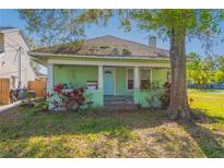 Charming single-story home with a cozy porch and mature landscaping at 313 Jefferson S Ave, Oldsmar, FL 34677