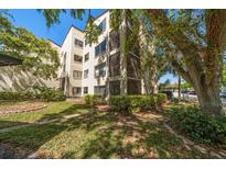 Charming condo building featuring private balconies and mature landscaping at 700 Starkey Rd # 1111, Largo, FL 33771