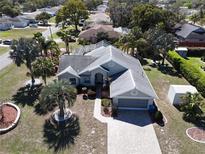 Lovely single-story home featuring a paved driveway, lush landscaping, and attached two-car garage at 10302 Belltower St, Spring Hill, FL 34608