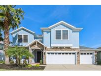 Charming two-story home with stone accents, a three-car garage, and a well-manicured lawn at 10642 Mistflower Ln, Tampa, FL 33647