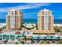 Beautiful waterfront condo buildings with beach views and colorful storefronts below on a sunny day at 11 San Marco St # 307, Clearwater Beach, FL 33767