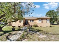 Charming one story home with a welcoming front porch and beautifully landscaped front yard at 2606 N Boulevard, Tampa, FL 33602