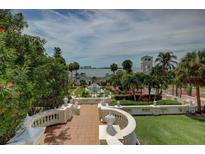 Expansive estate view featuring lush landscaping, manicured gardens, and architectural details overlooking the water at 820 Druid S Rd, Clearwater, FL 33756