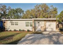 Charming single-story home with stone accents, fresh exterior paint, and well-manicured landscaping at 1012 Cronley Pl, Sarasota, FL 34237
