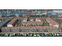 Aerial view of waterfront condos, showing boat docks, complex layout, and nearby waterway at 325 Madeira Cir, Tierra Verde, FL 33715
