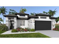 Stunning single-Gathering home featuring stone accents, black trim, lush landscaping and a two car garage at 389 Sun Chaser Dr, Nokomis, FL 34275