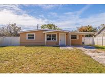 Charming single-story home featuring a cozy front porch, well-kept lawn, and attached carport at 8792 93Rd St, Seminole, FL 33777