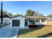 Charming single-story home featuring a freshly painted exterior, a well-manicured lawn, and a convenient attached garage at 9143 109Th Ave, Seminole, FL 33777