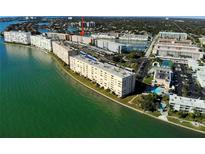Aerial view of waterfront condo complex with lush greenery, and convenient parking at 6025 Shore S Blvd # 611, Gulfport, FL 33707