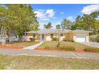 Charming yellow single-story home featuring an attached one-car garage and a well-maintained front yard at 7183 Fireside St, Spring Hill, FL 34606