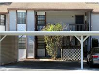 Condominium with tan exterior and carport parking at 12155 Environmental Dr # 6, New Port Richey, FL 34654