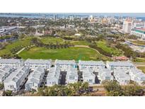 Beautiful aerial view of townhomes with a large green park and the city skyline in the background at 2500 Boone Ct, Sarasota, FL 34237