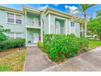 Charming two-story condo with well-maintained landscaping and a welcoming facade at 300 Promenade Dr # 106, Dunedin, FL 34698