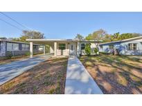 Charming single-story home with a covered carport and a well-maintained front yard at 3218 N 16Th St, Tampa, FL 33605