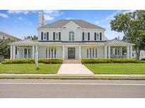 Beautiful two-story home with manicured lawn, a walkway, and a double-door entryway at 3801 Bayshore Blvd, Tampa, FL 33611