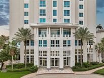 Grand building entrance with lush landscaping, palm trees, and elegant architectural details at 400 Beach Ne Dr # 1202, St Petersburg, FL 33701