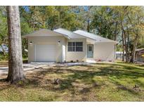 Charming single-story home with a well-maintained lawn and attached one car garage at 411 Virginia Ave, Brooksville, FL 34601