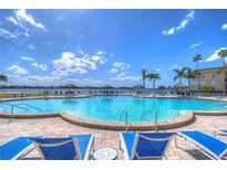 Enjoy the community pool with waterfront views and lounge seating in this relaxing outdoor space at 5220 Brittany S Dr # 807, St Petersburg, FL 33715