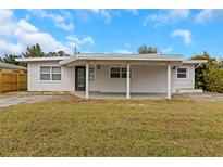 Charming single-story home featuring an open front carport and a well-maintained front lawn at 5813 18Th S Ave, Gulfport, FL 33707