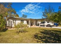 Charming home featuring a covered parking area, lush lawn, and inviting curb appeal at 7101 8Th N Ave, St Petersburg, FL 33710