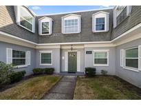 Charming two-story home with a manicured lawn, well-maintained landscaping and beautiful architectural details at 1719 Belleair Forest Dr # B, Belleair, FL 33756