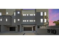 Contemporary condo exterior with private garages and modern architecture, illuminated at dusk at 1910 W North A St # 5, Tampa, FL 33606
