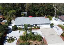 Aerial view of charming single-story home with well-manicured landscaping and beautiful water access at 201 79Th Ne Ave, St Petersburg, FL 33702