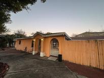 Charming single-story home with stucco walls, gated archway, and a well-maintained front yard at 3111 W Spruce St, Tampa, FL 33607