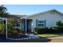 Charming single-story home featuring a quaint blue door and vibrant, well-maintained landscaping at 411 Bloom Ct # 2A, Sun City Center, FL 33573