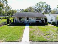 Charming single-story home with a well-manicured lawn and inviting walkway to the front door at 4976 12Th N Ave, St Petersburg, FL 33710