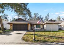 Charming single-story home featuring stone accents, neutral paint, and a well-manicured lawn at 7208 Baltusrol Dr, New Port Richey, FL 34654