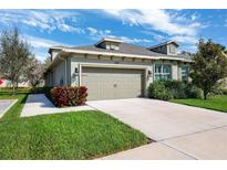 Charming single-story home featuring a two-car garage and well-maintained landscaping at 1467 Twin Villas Way, Dunedin, FL 34698