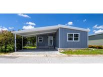 Charming single-story home with covered parking and neat landscaping at 163 Dolphin E Dr, Oldsmar, FL 34677