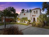 Stunning two-story home featuring a red tile roof, white stucco exterior, and beautiful landscaping at 2227 29Th S St, St Petersburg, FL 33712