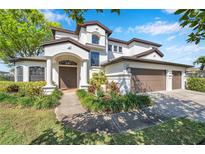 Elegant two-story home features manicured landscaping and a grand entrance with arched doorway and attached three-car garage at 3598 10Th Ne St, St Petersburg, FL 33704