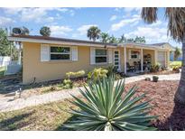 Charming single-story home with a well-manicured front yard and inviting curb appeal under a sunny sky at 375 Magnolia Rd, Venice, FL 34293