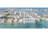 Wonderful aerial view showcasing the gorgeous waterfront condo community with boat docks and city views at 400 Island Way # 908, Clearwater Beach, FL 33767