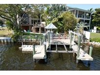 This waterfront home features a private dock with boat lift, perfect for enjoying waterfront living at 4035 N River View Ave, Tampa, FL 33607