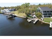 Beautiful waterfront home featuring multiple docks and outdoor spaces for enjoying the serene views at 4035 N River View Ave, Tampa, FL 33607