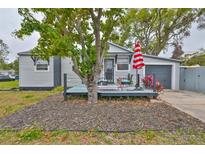 Charming single-story home featuring gray siding, front deck with seating, and a cozy, inviting curb appeal at 5601 2Nd N Ave, St Petersburg, FL 33710