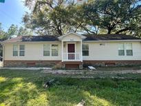 Charming single-story home with a welcoming front porch and well-lit windows, perfect for a cozy lifestyle at 902 Estelle Ave, Brandon, FL 33511