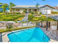 Charming single-Gathering home featuring a well-manicured front yard and inviting pool area perfect for outdoor enjoyment at 1906 Del Oro Ct, Dunedin, FL 34698