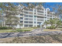 Stunning multi-story condominium with lush landscaping, driveway, and well-maintained facade surrounded by mature trees at 2333 Feather Sound Dr # A204, Clearwater, FL 33762