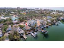 Waterfront home boasts a boat dock and lush landscaping near coastal scenery at 300 16Th Ave, Indian Rocks Beach, FL 33785