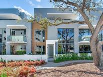 Modern condo featuring sleek architectural design, large windows, and lush landscaping, creating a serene outdoor living space at 3030 W Santiago St # 3, Tampa, FL 33629