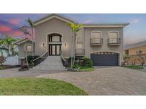 Elegant two-story home with lush landscaping, grand entrance, and a two-car garage at 116 9Th E St, Tierra Verde, FL 33715