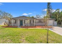 Charming single-story home with a well-manicured lawn, inviting curb appeal, and covered porch with stylish accents at 1524 78Th N Ter, St Petersburg, FL 33702