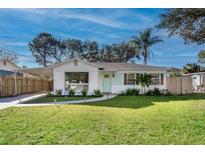 Charming single-story home featuring a well-manicured lawn, a carport and lovely landscaping at 3316 W Ballast Point Blvd, Tampa, FL 33611