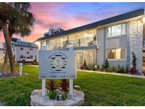 Condominium complex features lush landscaping and prominent signage against a colorful dusk sky at 4400 37Th S St # 4, St Petersburg, FL 33711